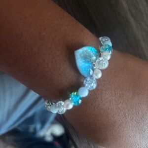 Blue and white beaded bracelet with blue heart charm